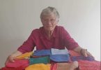 Member Rowena’s mother Peggy with some of her many knitted squares