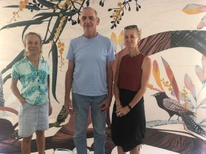 From left, local artists Mo Riggs and Scott Taylor with mural artist EJ Zyla in front of the workshop mural. Photo credit: Denise Orr