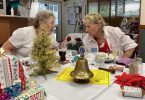Ann and Cherryl deep in conversation over a Christmas cracker!