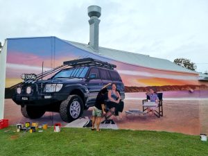 Rainbow Beach’s mural trail (pictured here in progress by artist James R Ellis) was a part of last year’s Studio Trails. Get your application in now to participate in this year’s event.
