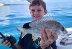 Tin Can Bay Fishing Club - Connor Lyell with a bream he caught