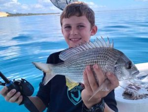 Tin Can Bay Fishing Club - Connor Lyell with a bream he caught