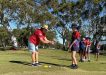 Junior Golfing Coordinator Janet Reibel helps Mary with her putting. Photo credit: Tin Can Bay P-10 School